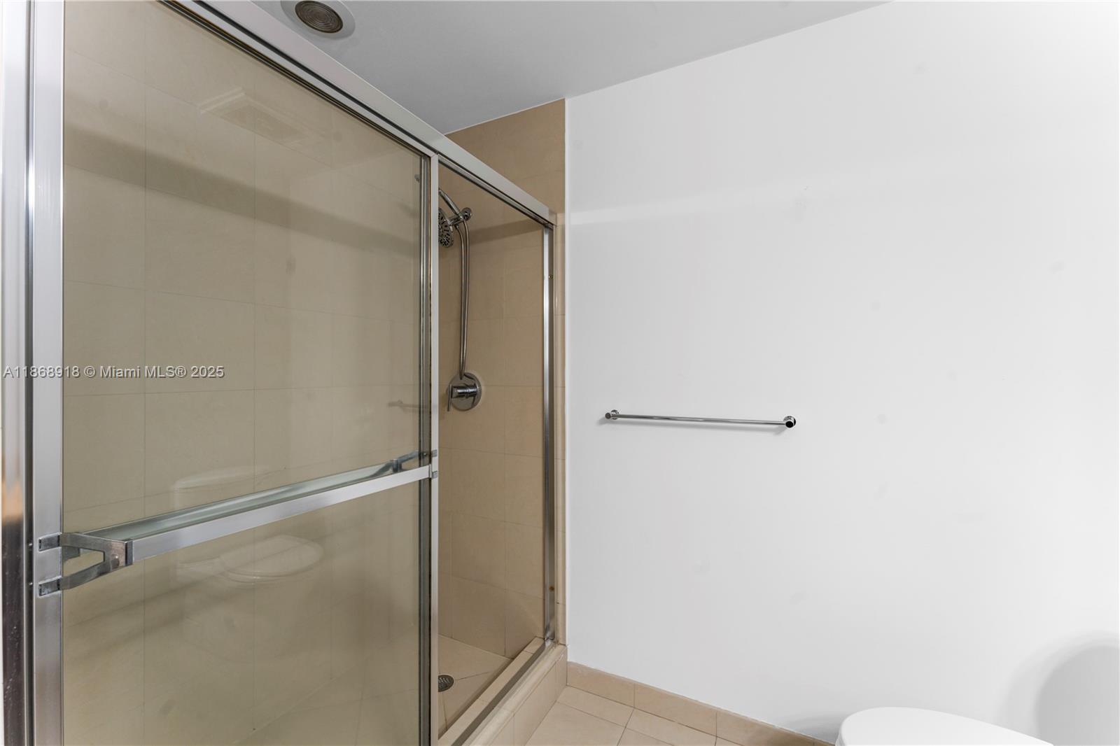 3029 Northeast 188th Street, Unit 924 Aventura, FL 33180 - Photo 10 of 20 a bathroom with a glass shower door