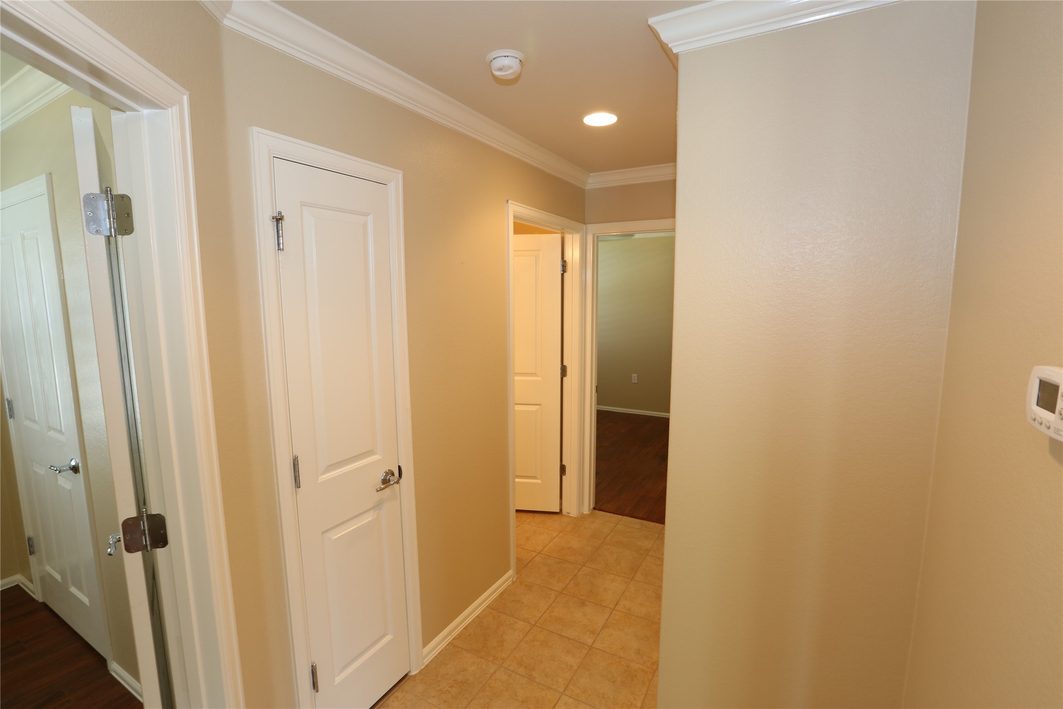113 Monument Hill Trail Georgetown, TX 78633 - Photo 19 of 29 Hall with crown molding, recessed lighting, and light tile patterned floors