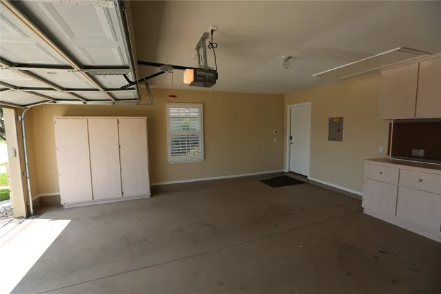 a view of empty room with windows and flat screen tv
