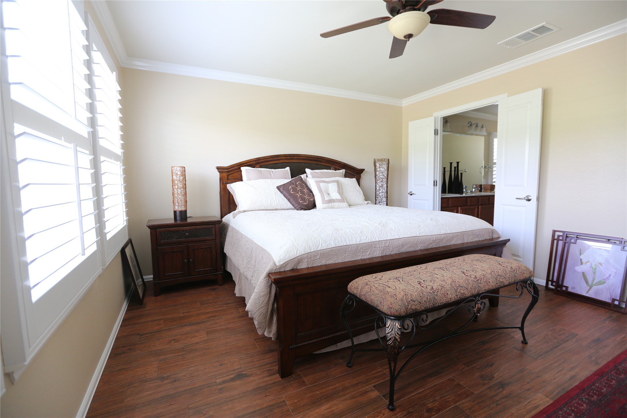 113 Monument Hill Trail Georgetown, TX 78633 - Photo 25 of 29 Bedroom featuring ornamental molding, dark wood-style floors, a ceiling fan, and ensuite bathroom
