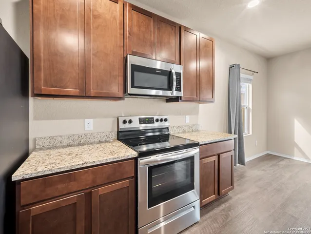 a kitchen with a stove microwave and sink