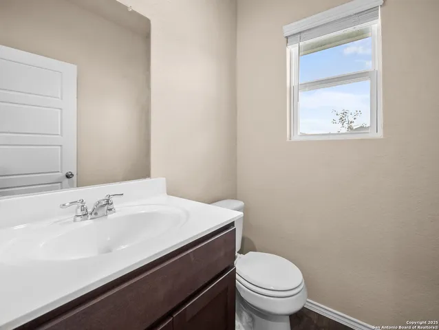 a bathroom with a sink a toilet and a mirror