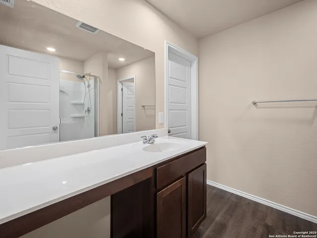a bathroom with a glass shower door