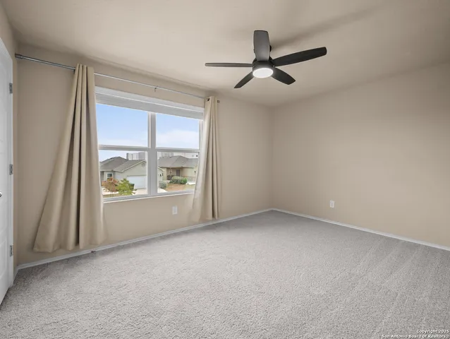 an empty room with a ceiling fan and a ceiling fan