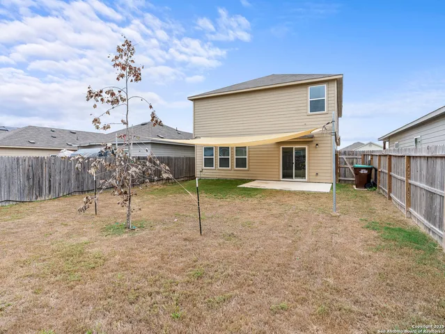a view of a house with a backyard