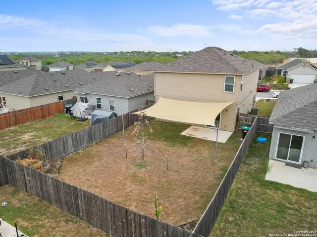 an aerial view of a house with a yard