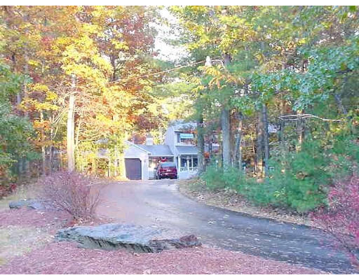 487 Reservoir Road Lunenburg, MA 01462 - Photo 20 of 22 a view of a road with plants and large trees