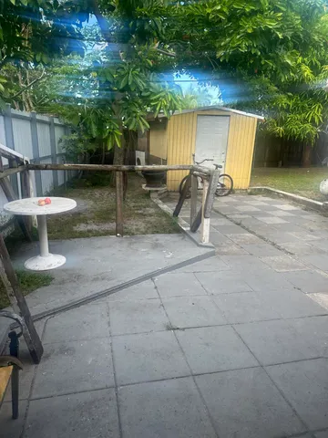 a view of backyard with outdoor seating and barbeque oven