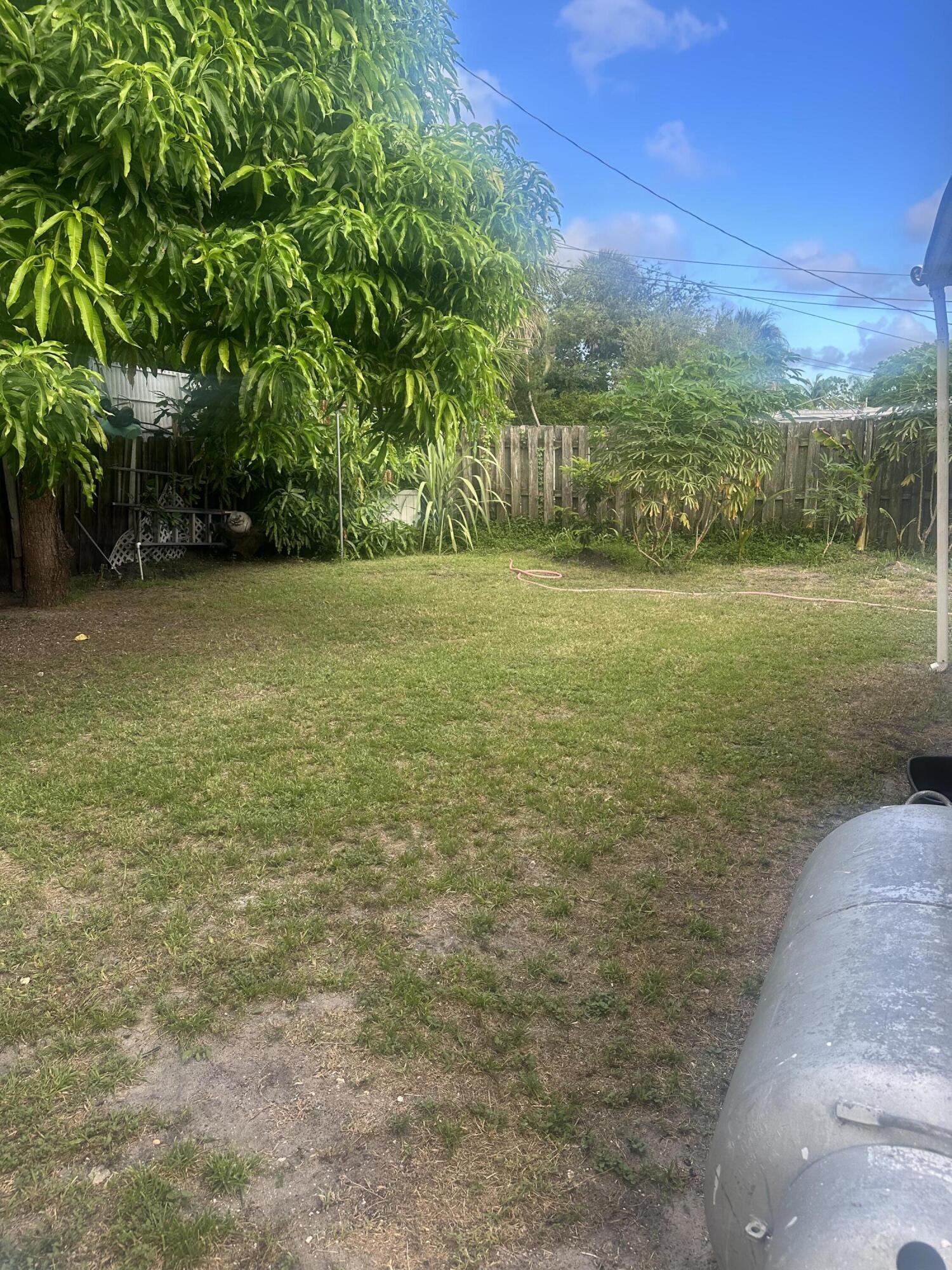 916 Caroline Avenue West Palm Beach, FL 33413 - Photo 13 of 14 a view of a field with an trees