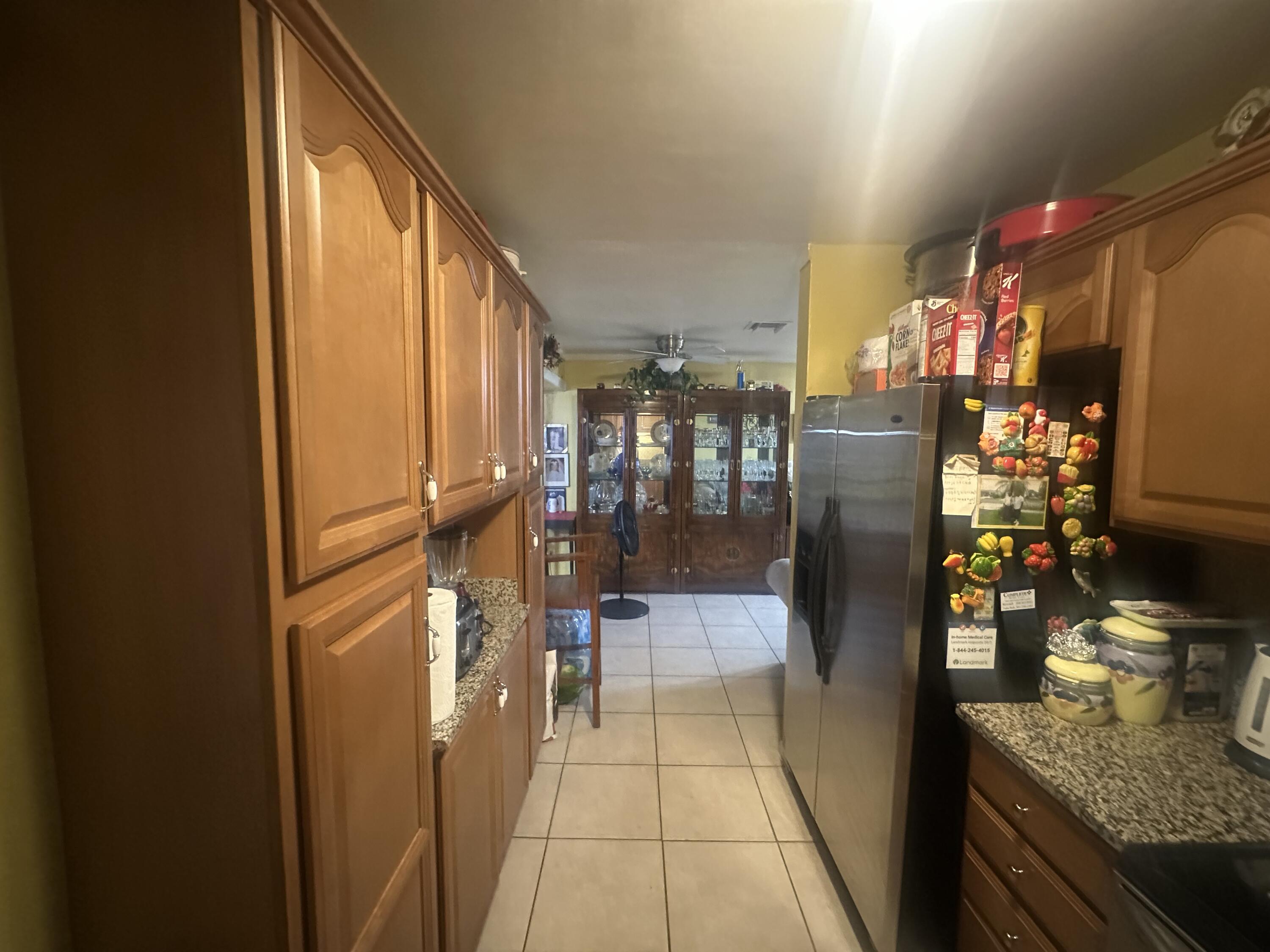 916 Caroline Avenue West Palm Beach, FL 33413 - Photo 4 of 14 a hallway with painting on the wall and a potted plant