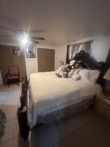 a bedroom with a bed and a lamp