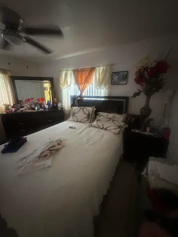 a bed sitting in a room next to a window