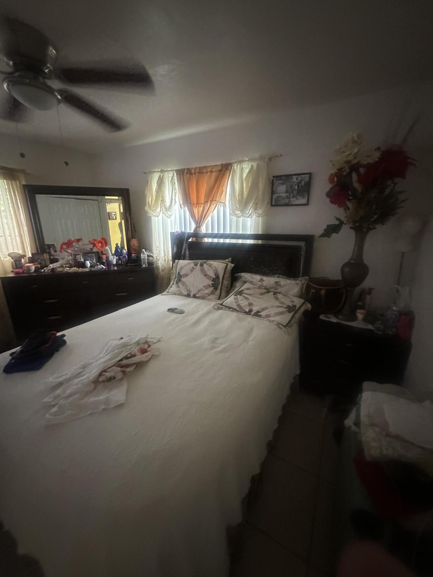 916 Caroline Avenue West Palm Beach, FL 33413 - Photo 7 of 14 a bed sitting in a room next to a window