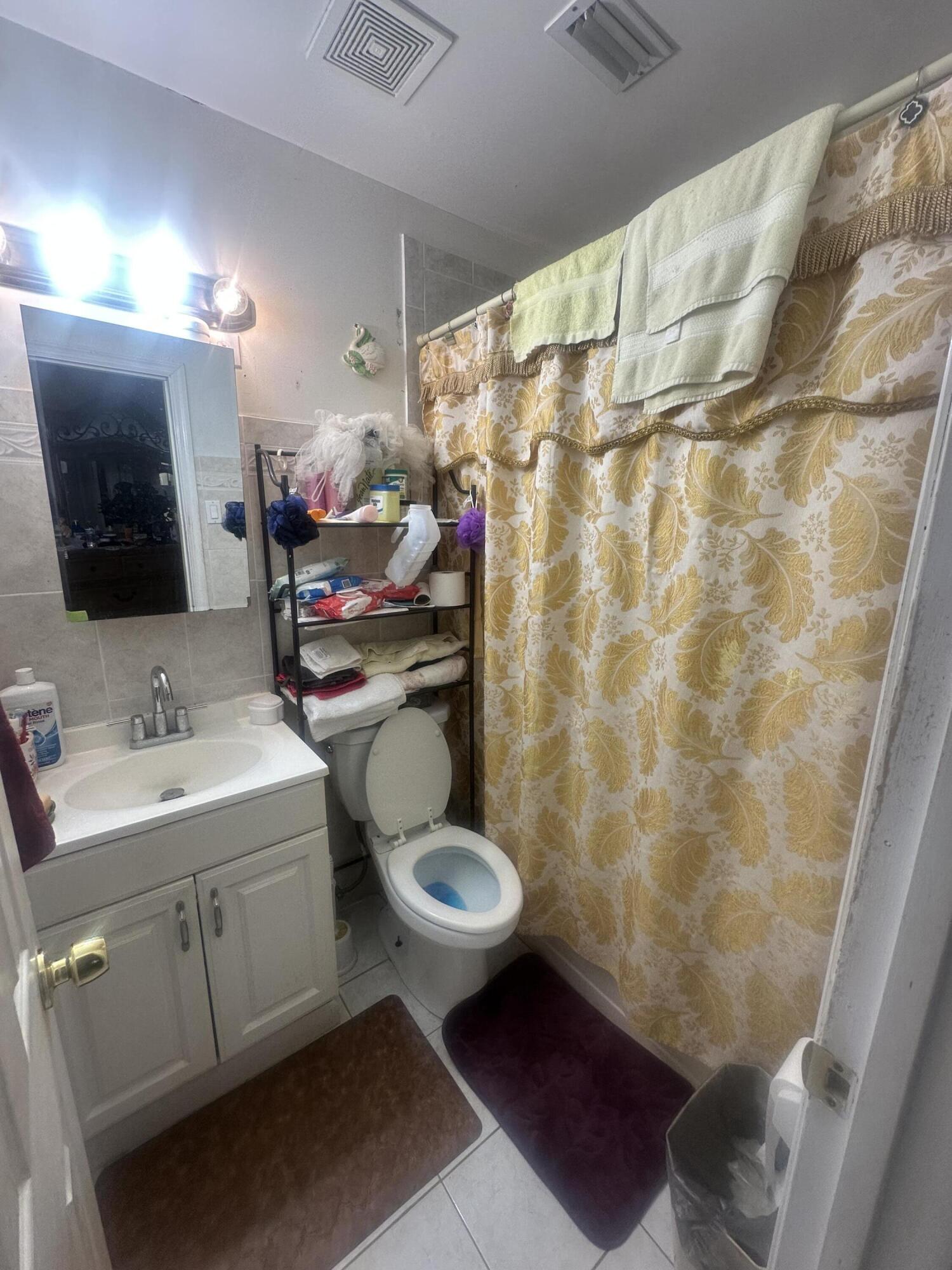 916 Caroline Avenue West Palm Beach, FL 33413 - Photo 10 of 14 a bathroom with a sink toilet and shower
