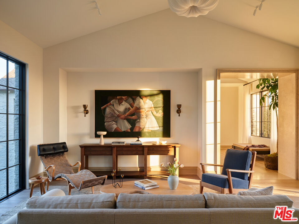 694 North Tigertail Road Los Angeles, CA 90049 - Photo 18 of 34 a living room with furniture and a flat screen tv