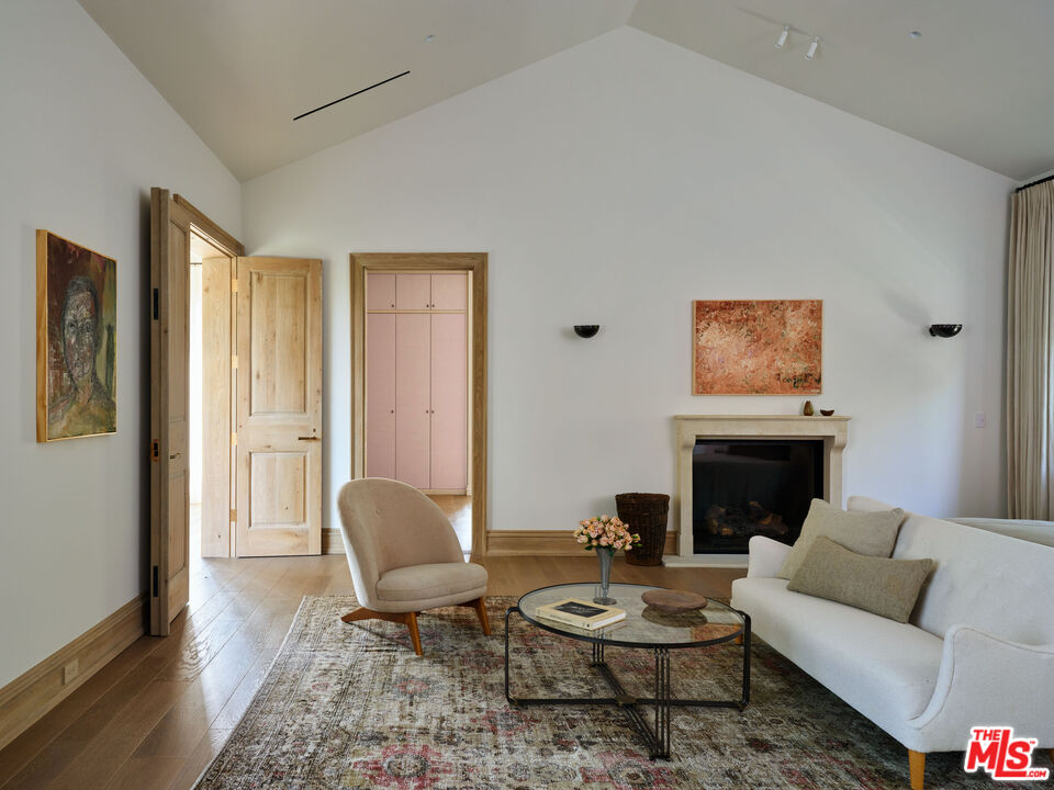 694 North Tigertail Road Los Angeles, CA 90049 - Photo 19 of 34 a living room with furniture and a fireplace