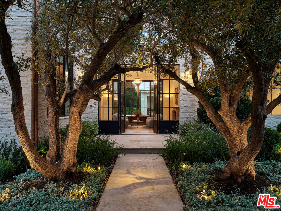 694 North Tigertail Road Los Angeles, CA 90049 - Photo 2 of 34 a view of a house with sitting area and garden