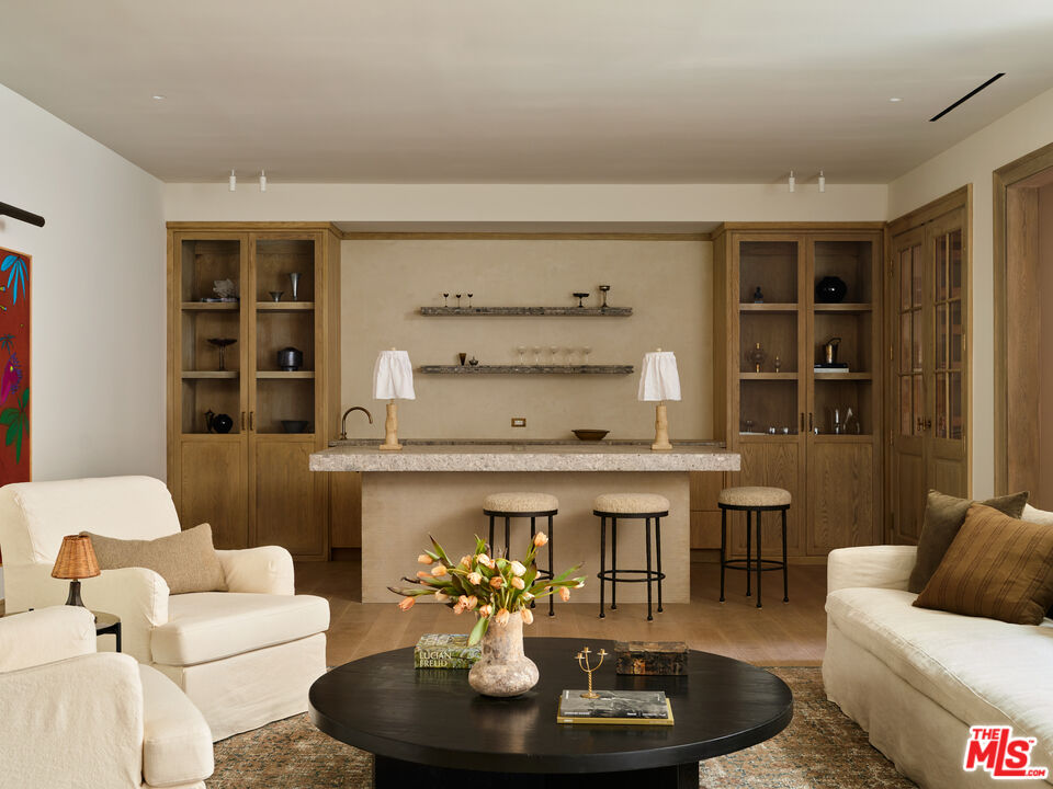694 North Tigertail Road Los Angeles, CA 90049 - Photo 27 of 34 a living room with furniture and a fireplace