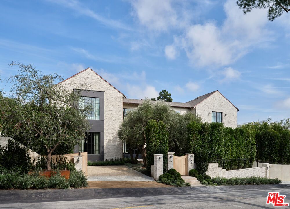 694 North Tigertail Road Los Angeles, CA 90049 - Photo 34 of 34 a front view of a house with a yard and garage
