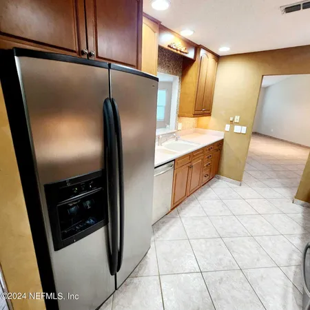 a kitchen with stainless steel appliances granite countertop a refrigerator and a stove