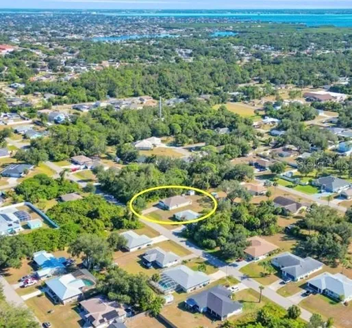 a front view of a house with a yard and potted plants
