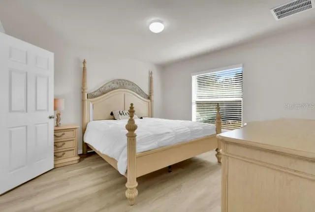 a bathroom with a granite countertop sink a toilet and a mirror