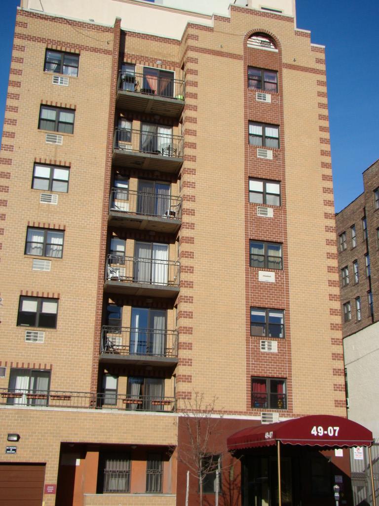 49-07 43rd Avenue, Unit 7F Queens, NY 11377 - Photo 15 of 16 a front view of a building with glass windows