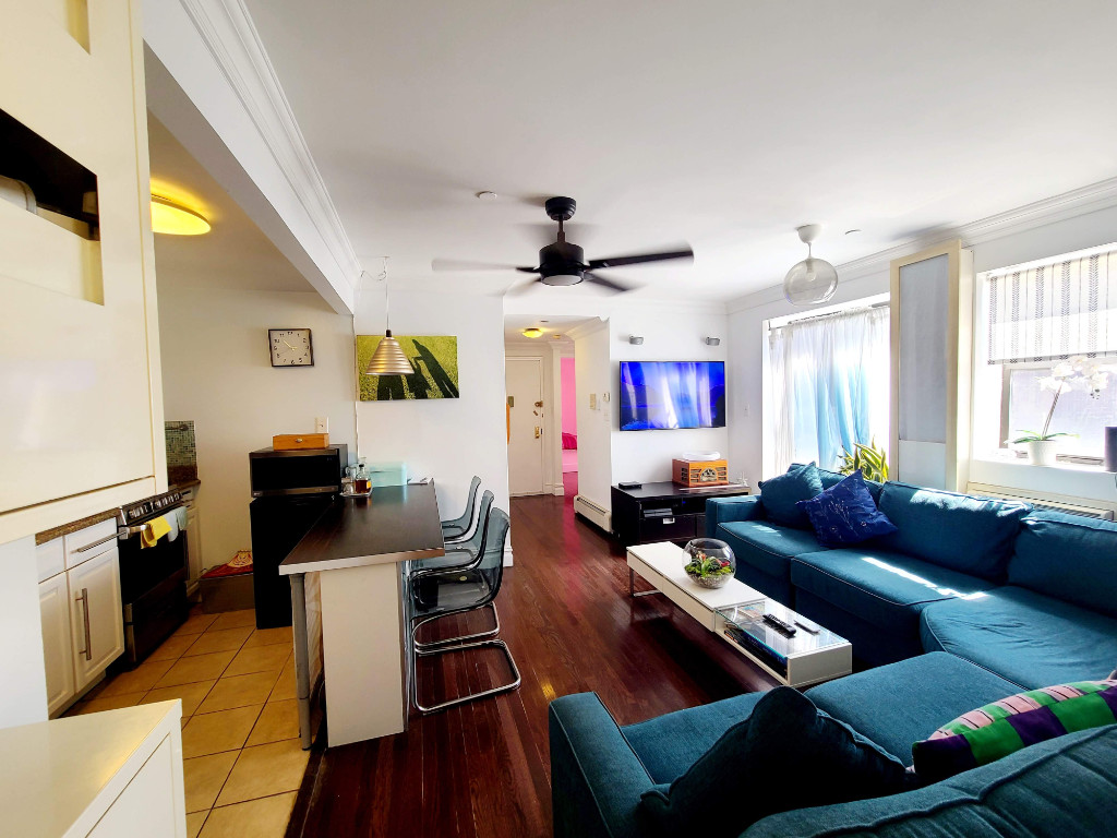 49-07 43rd Avenue, Unit 7F Queens, NY 11377 - Photo 4 of 16 a living room with furniture and a window