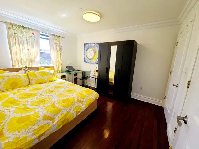 a bed sitting in a bedroom next to a window