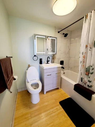 a bathroom with a sink toilet and shower