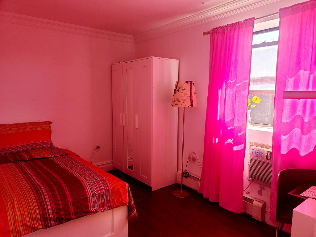 49-07 43rd Avenue, Unit 7F Queens, NY 11377 - Photo 9 of 16 a bedroom with a bed and a window