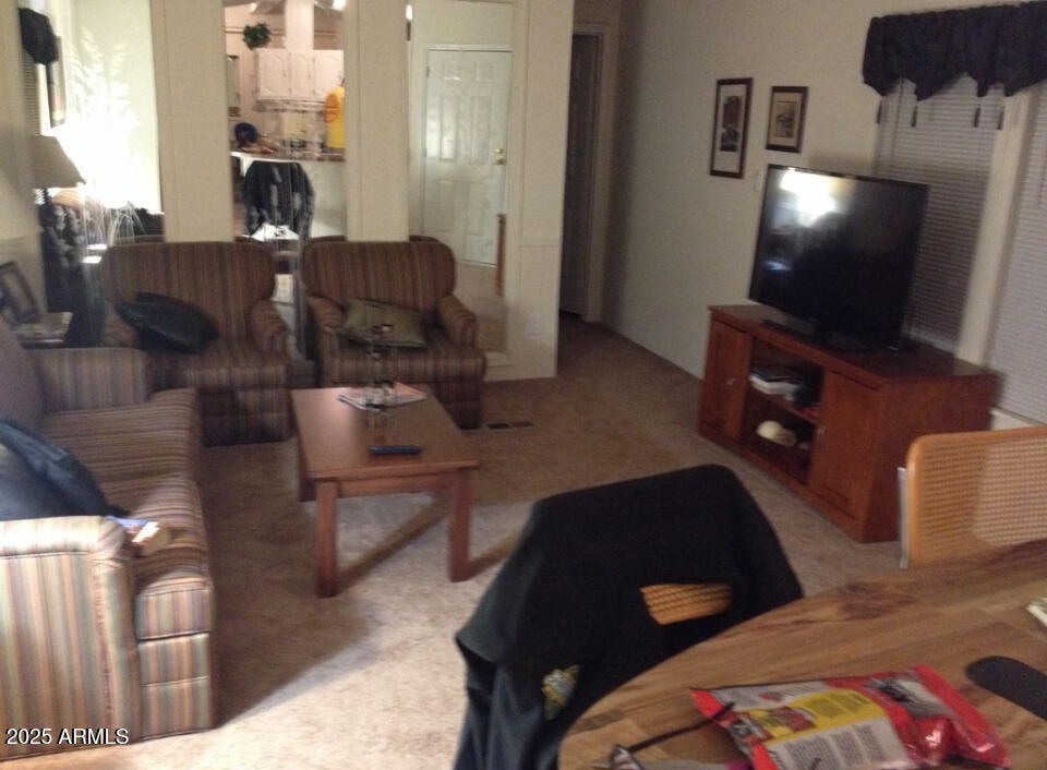 834 South Meridian Road, Unit 173 Apache Junction, AZ 85120 - Photo 5 of 6 a living room with furniture and a flat screen tv