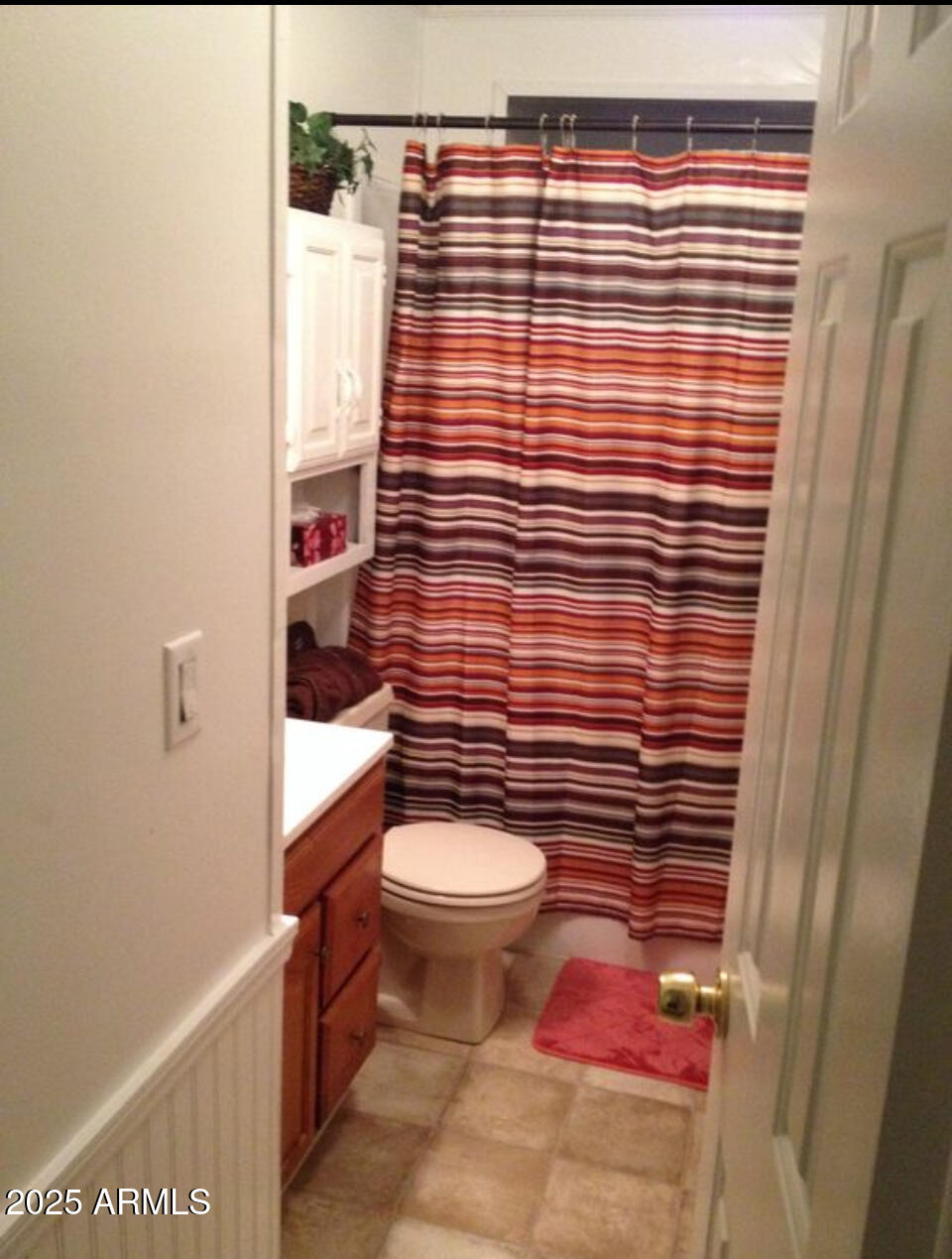 834 South Meridian Road, Unit 173 Apache Junction, AZ 85120 - Photo 6 of 6 a bathroom with a toilet and a shower curtain