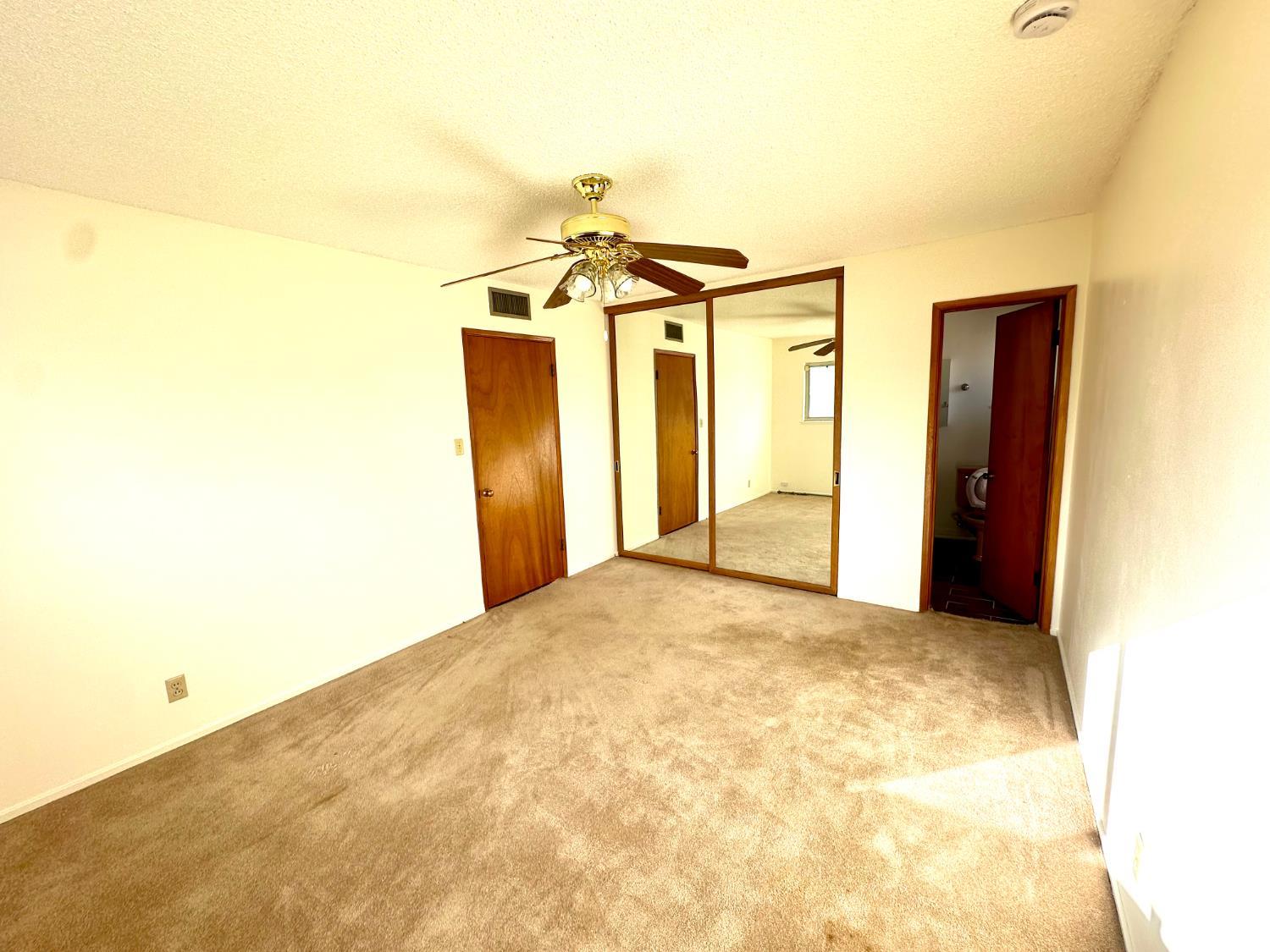 Undisclosed Address Delano, CA 93215 - Photo 1 of 14 a view of a big room with closet and a chandelier