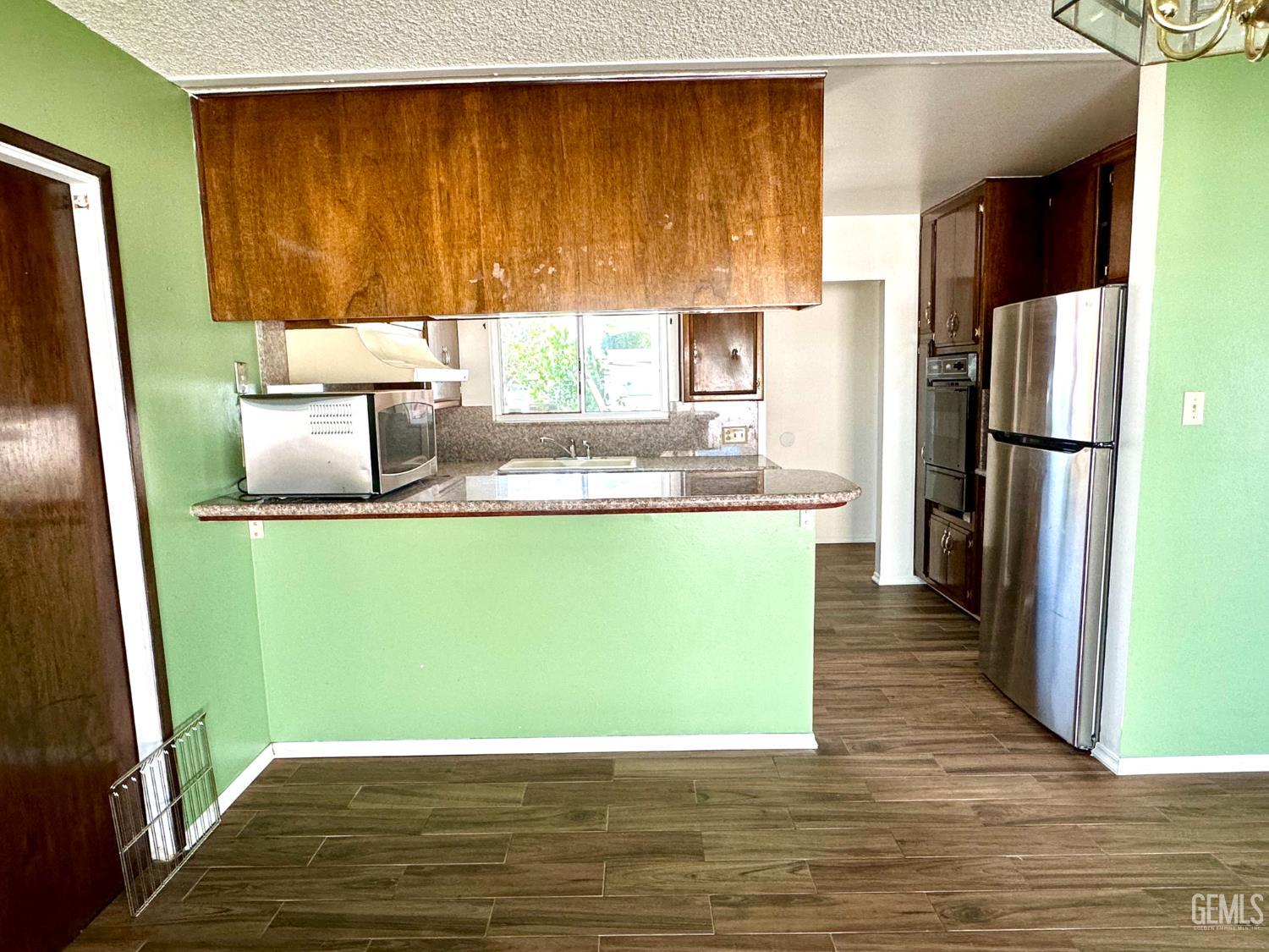 Undisclosed Address Delano, CA 93215 - Photo 12 of 14 a kitchen with a refrigerator and a sink