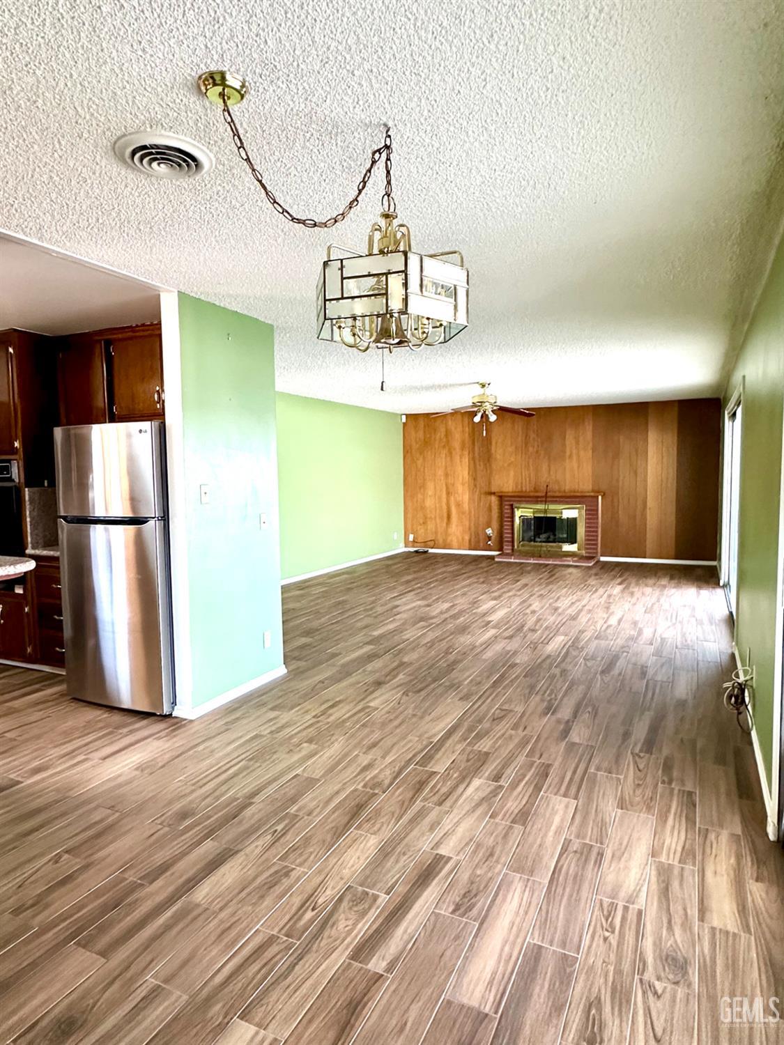 Undisclosed Address Delano, CA 93215 - Photo 13 of 14 a view of a room with wooden floor kitchen view and a window