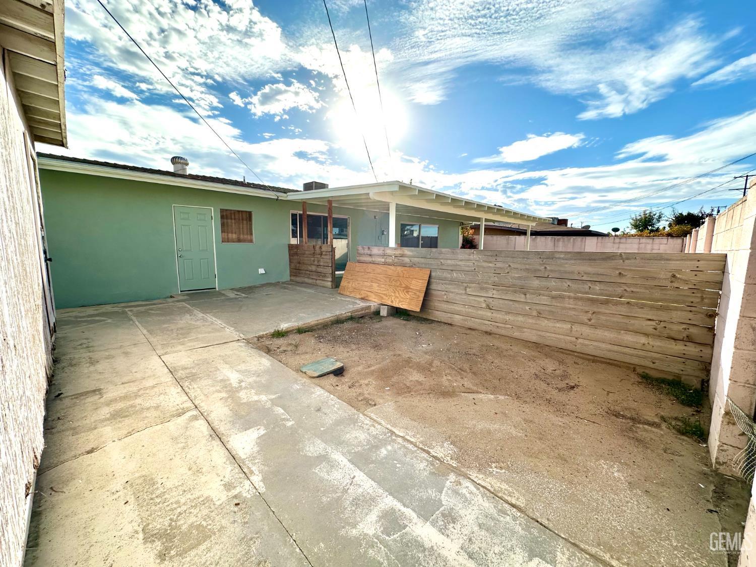 Undisclosed Address Delano, CA 93215 - Photo 7 of 14 a view of a house with a backyard
