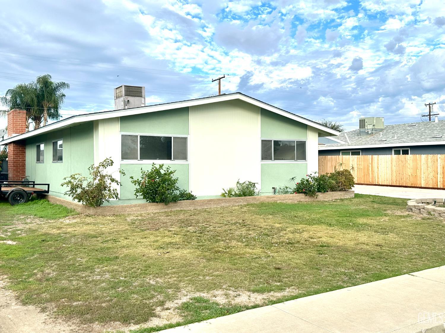 Undisclosed Address Delano, CA 93215 - Photo 9 of 14 a front view of house with yard and trees
