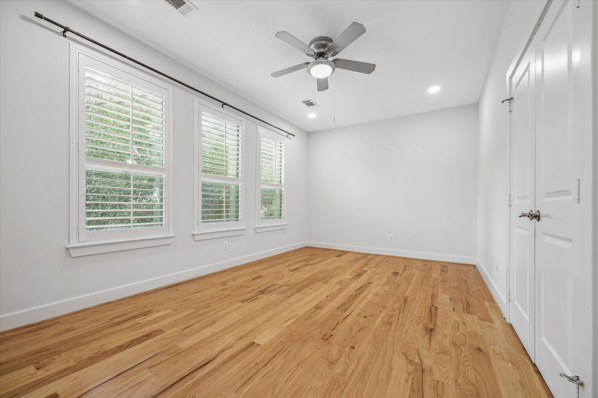 1468 California Street Houston, TX 77006 - Photo 17 of 23 Secondary Bedroom located on the 3rd floor features wood floors and overlooks the front of the home.