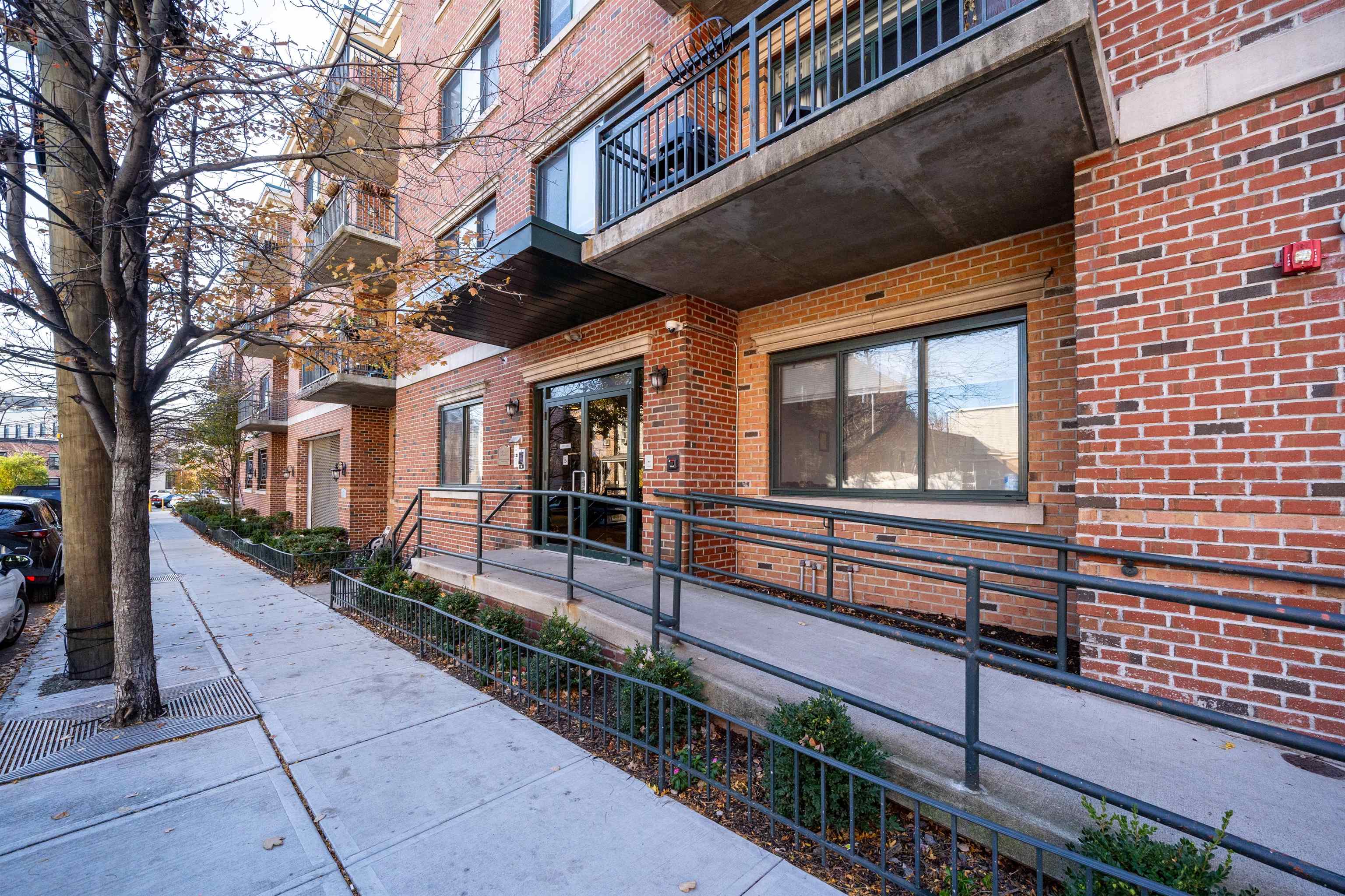 85 Maple Street, Unit 2L Weehawken, NJ 07086 - Photo 11 of 11 a view of a house with a small yard and a large tree