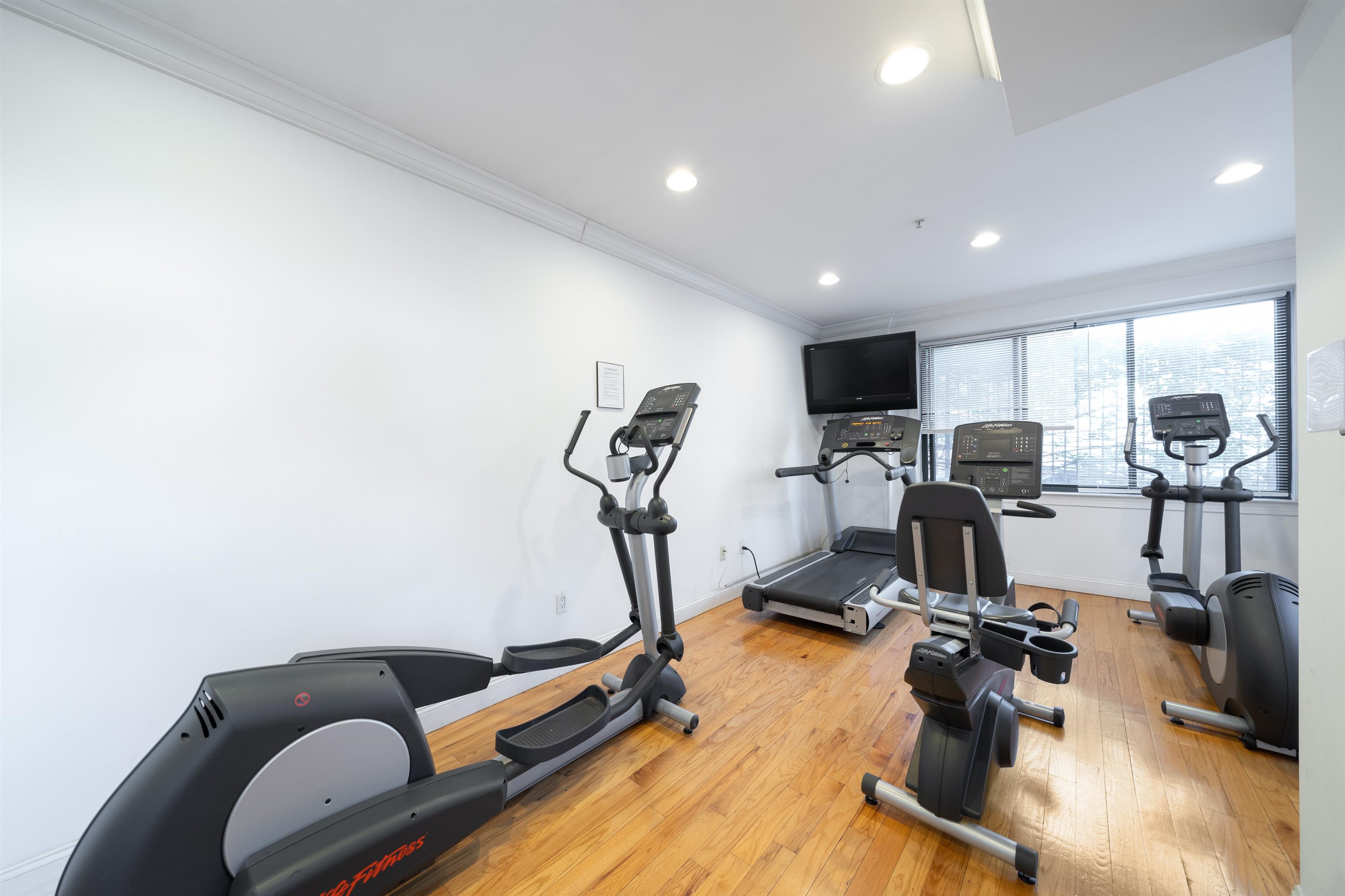 85 Maple Street, Unit 2L Weehawken, NJ 07086 - Photo 8 of 11 a view of a room with gym equipment