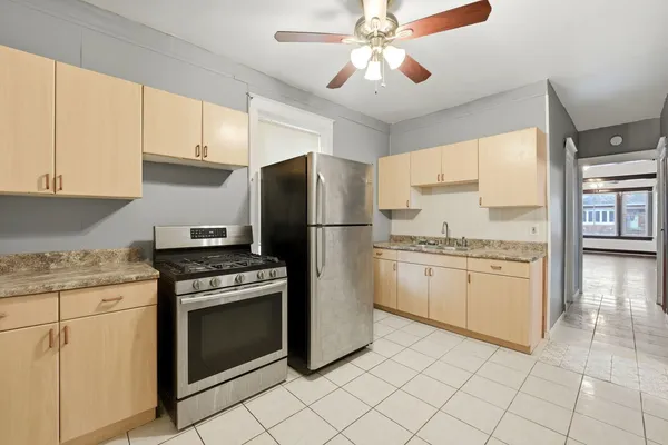 a kitchen with a stove sink and refrigerator