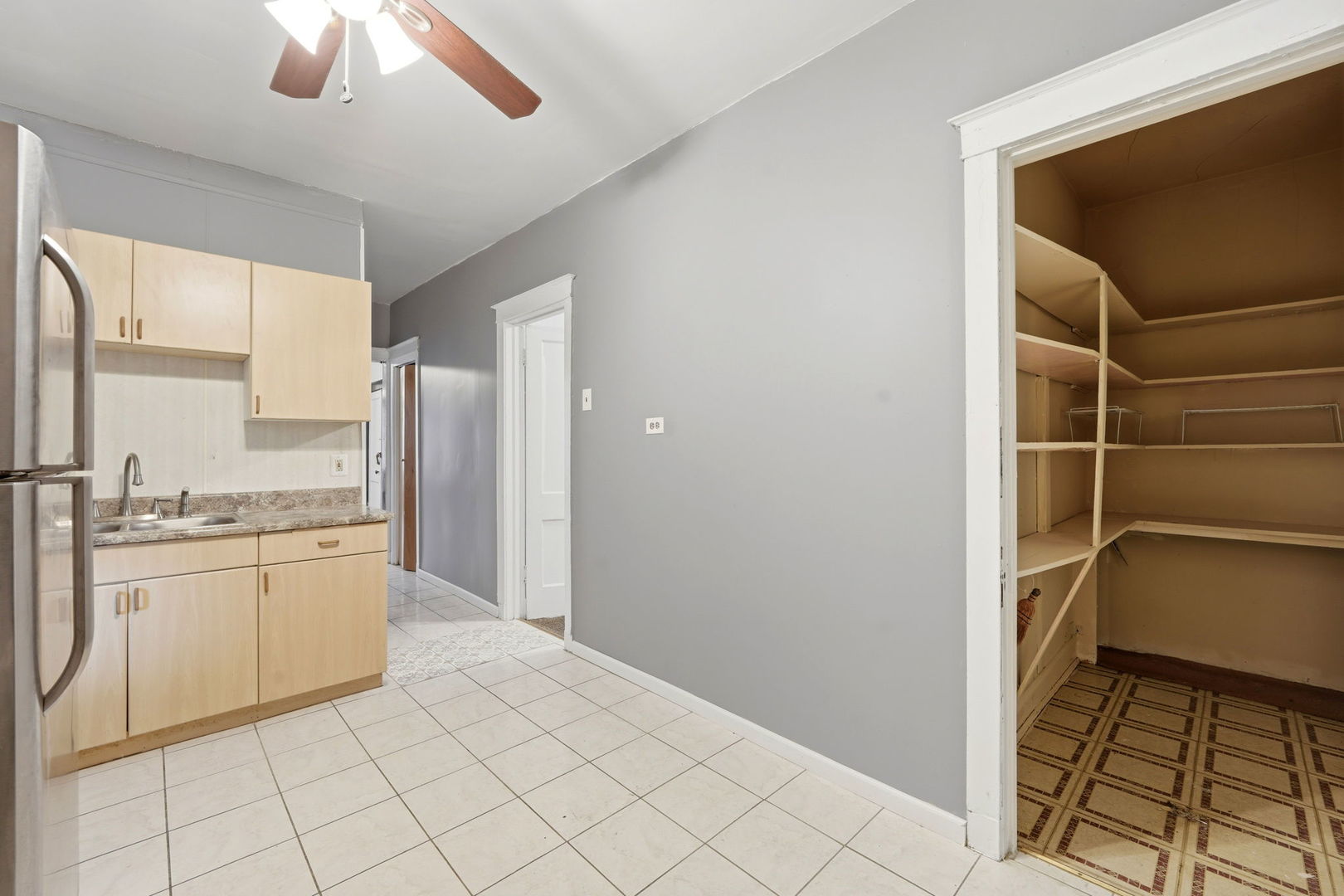 7923 South Carpenter Street Chicago, IL 60620 - Photo 12 of 34 a kitchen with a refrigerator a stove a sink and a window