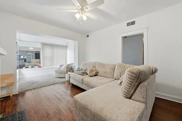 a living room with furniture and a large mirror