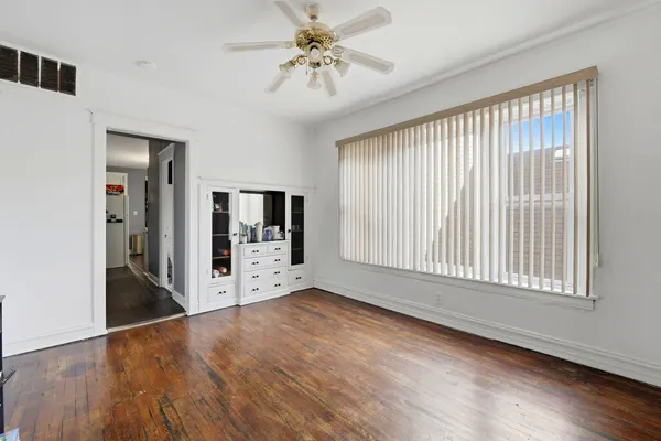 a view of a workspace with furniture and wooden floor