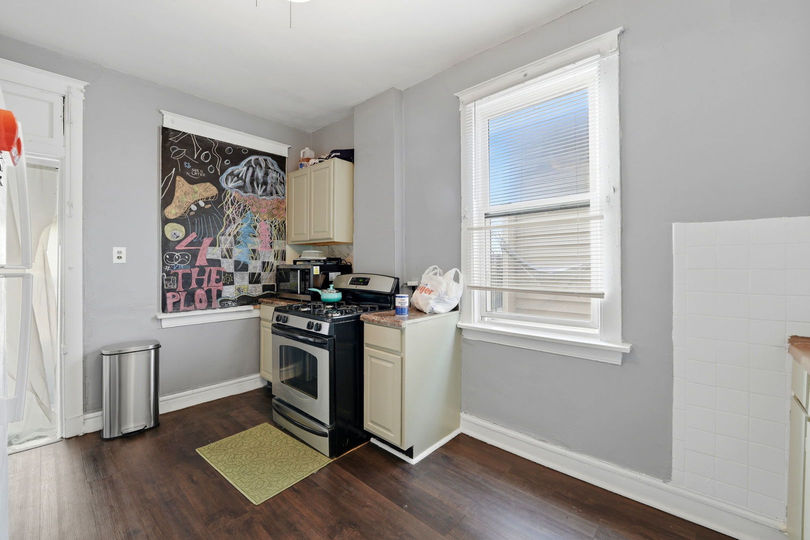7923 South Carpenter Street Chicago, IL 60620 - Photo 19 of 34 a kitchen with stainless steel appliances a stove and a window
