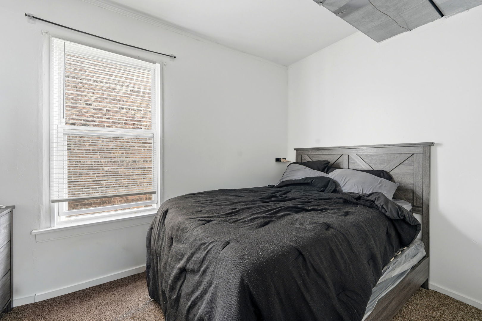 7923 South Carpenter Street Chicago, IL 60620 - Photo 23 of 34 a bed sitting in a bedroom next to a window