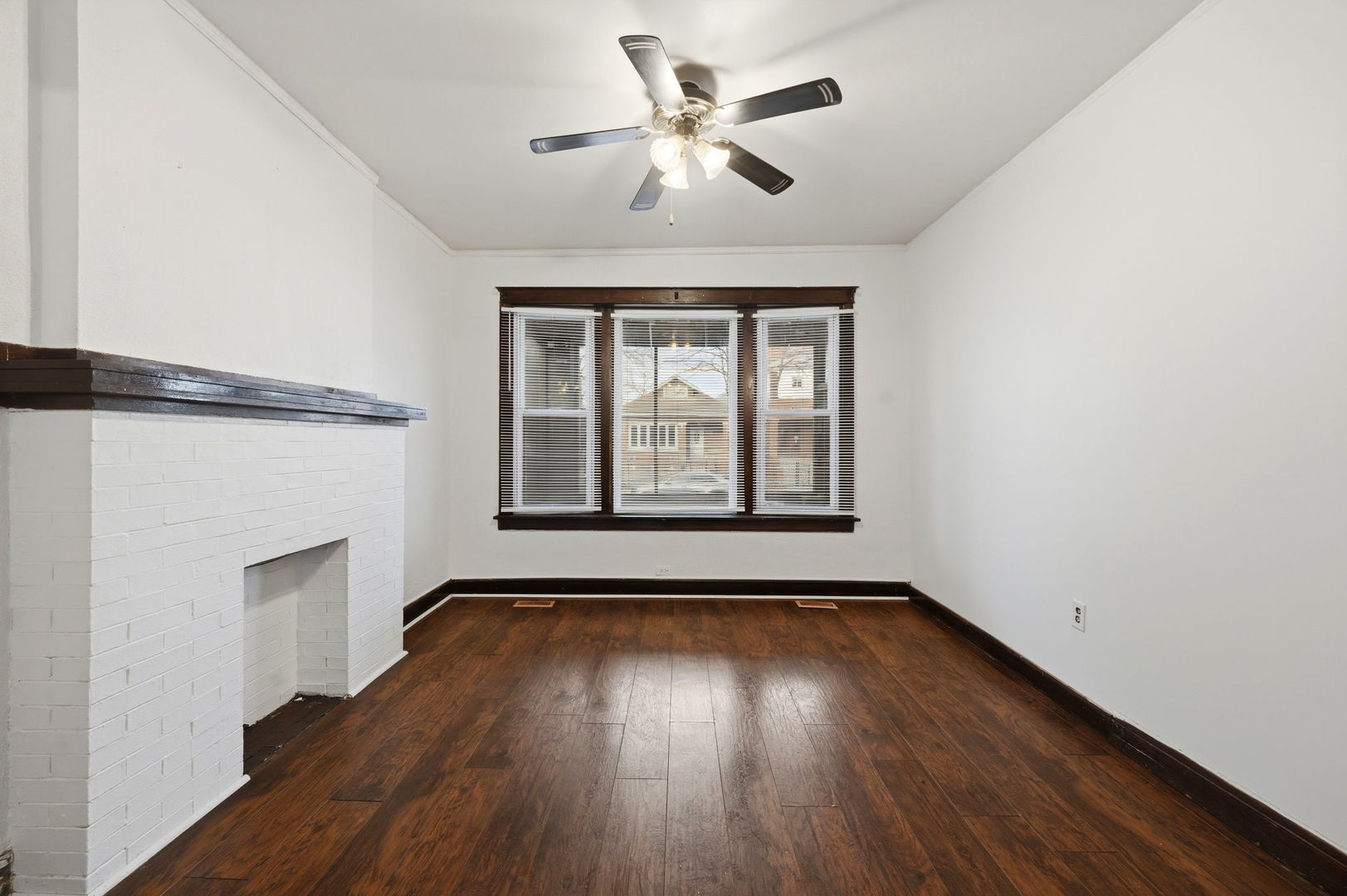7923 South Carpenter Street Chicago, IL 60620 - Photo 4 of 34 a view of an empty room with wooden floor and a window