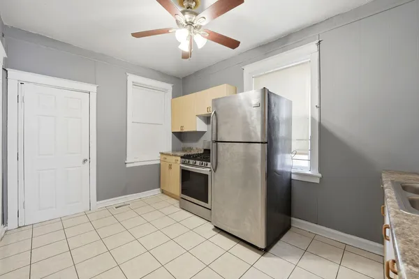 a kitchen with granite countertop a refrigerator and a sink