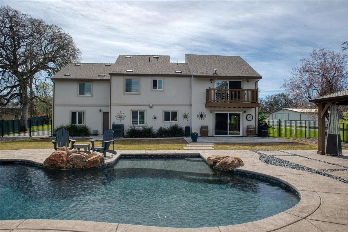 a view of a house with swimming pool and a yard